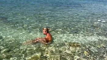 Slender tanned blonde gets fucked on the beach by the sound of waves during a photo shoot