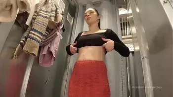 I try on clothes in fitting room with open curtain.
