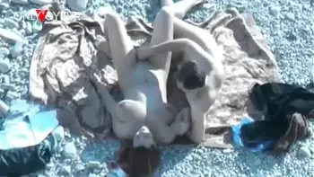 Beach Voyeur. Hot babe with big natural tits gives head on a public beach