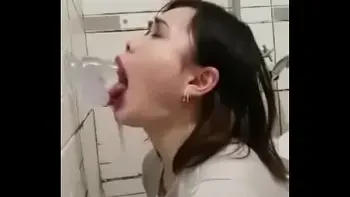 Asian deepthroating a dildo