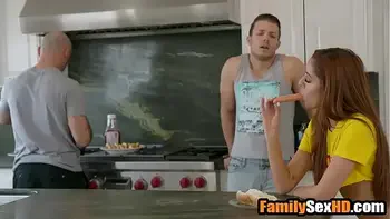 Teen stepsister teasing step brother behind stepdad's back