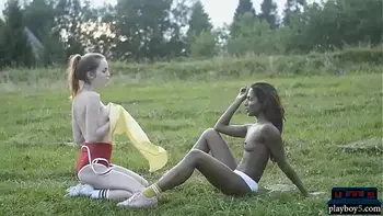 Dark and white chocolate lesbian play in the outdoors