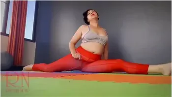 Regina Noir In A Woman In Yoga Leotards Practices Yoga In The Gym. Transparent Red Leotard Yoga