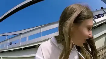 Talia Mint plays in public with remote control toy over the phone with fan