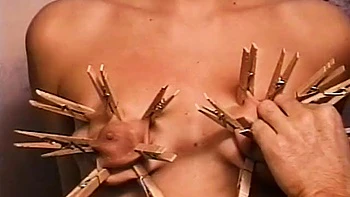 Horny dude loves putting clothes pegs on his slaves tits