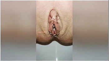 Beautiful Bald Pussy Of Petite Milf Makes The Big Powerful Urine Fountain Close Up