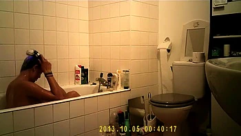 Brunette uses the toilet and takes a shower