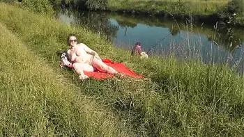 MILF sexy Frina on river bank undressed and sunbathes naked. Random man fisherman watching for her, and in the end decided to join naked woman. Wild beach. Nudist beach. Public nudity. Public exposure. Naked in public